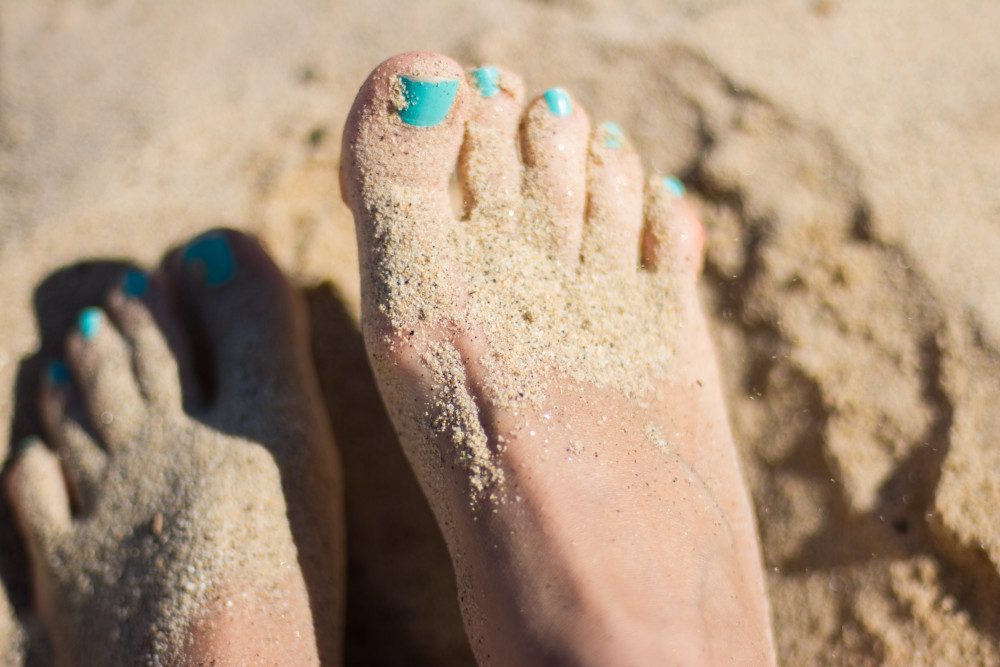 painted toes at the beach
