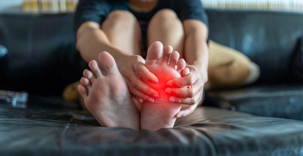 person holding their foot in pain